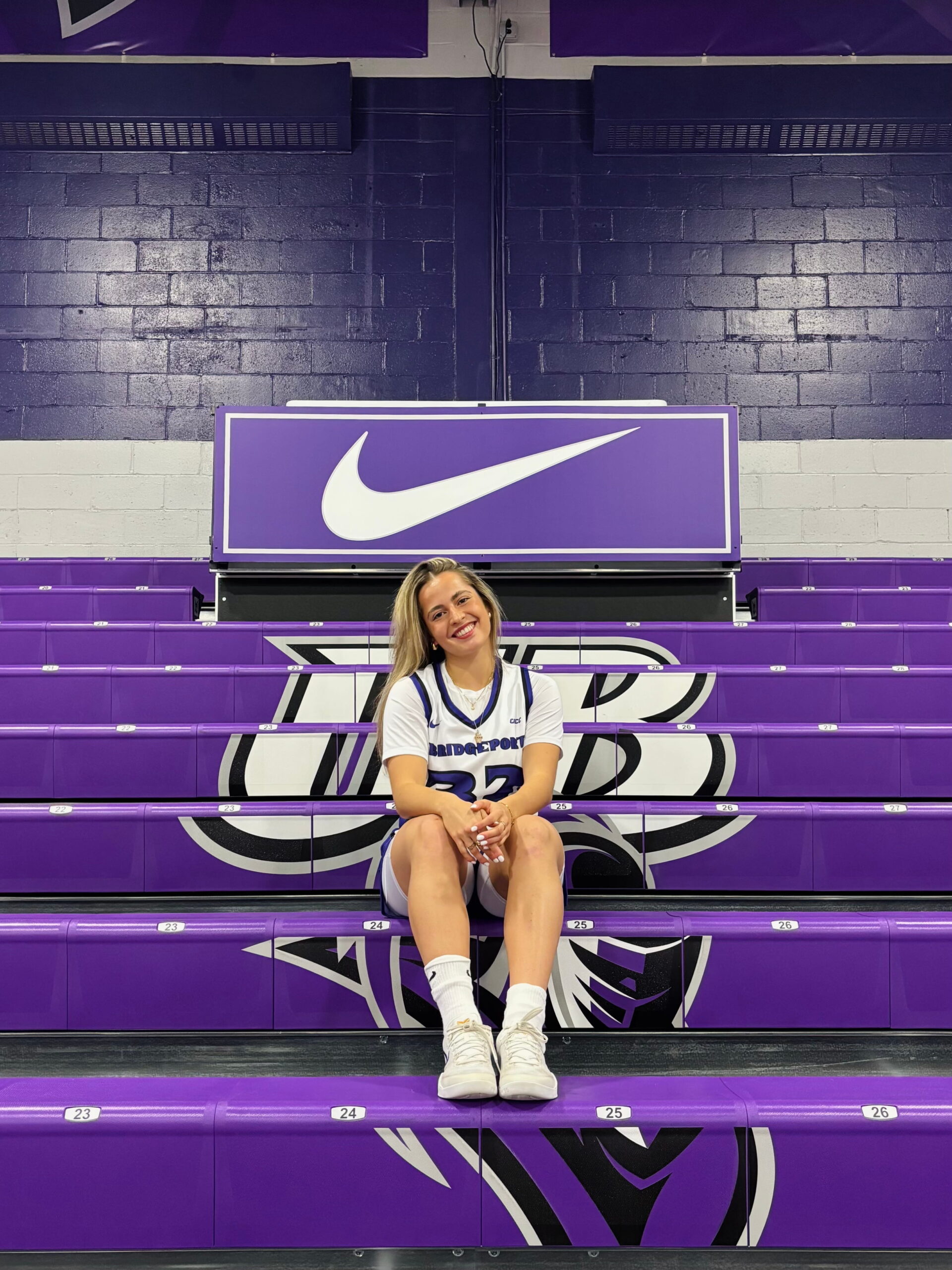 Laia Albàs Ferrer sitting on the bleachers in the gym at UB's Wheeler Recreation Center