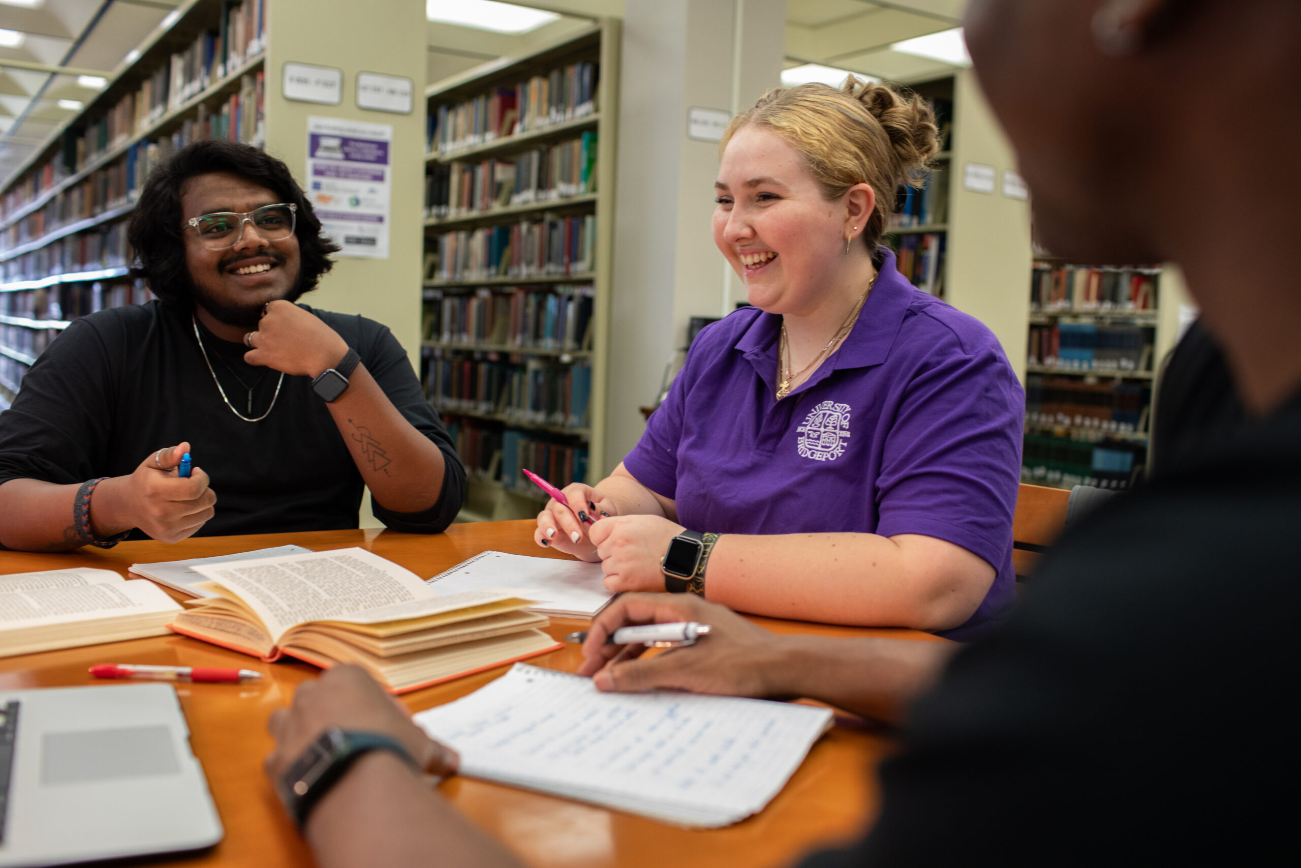 Students collaborating at a large table on the third floor of Wahlstrom Library.